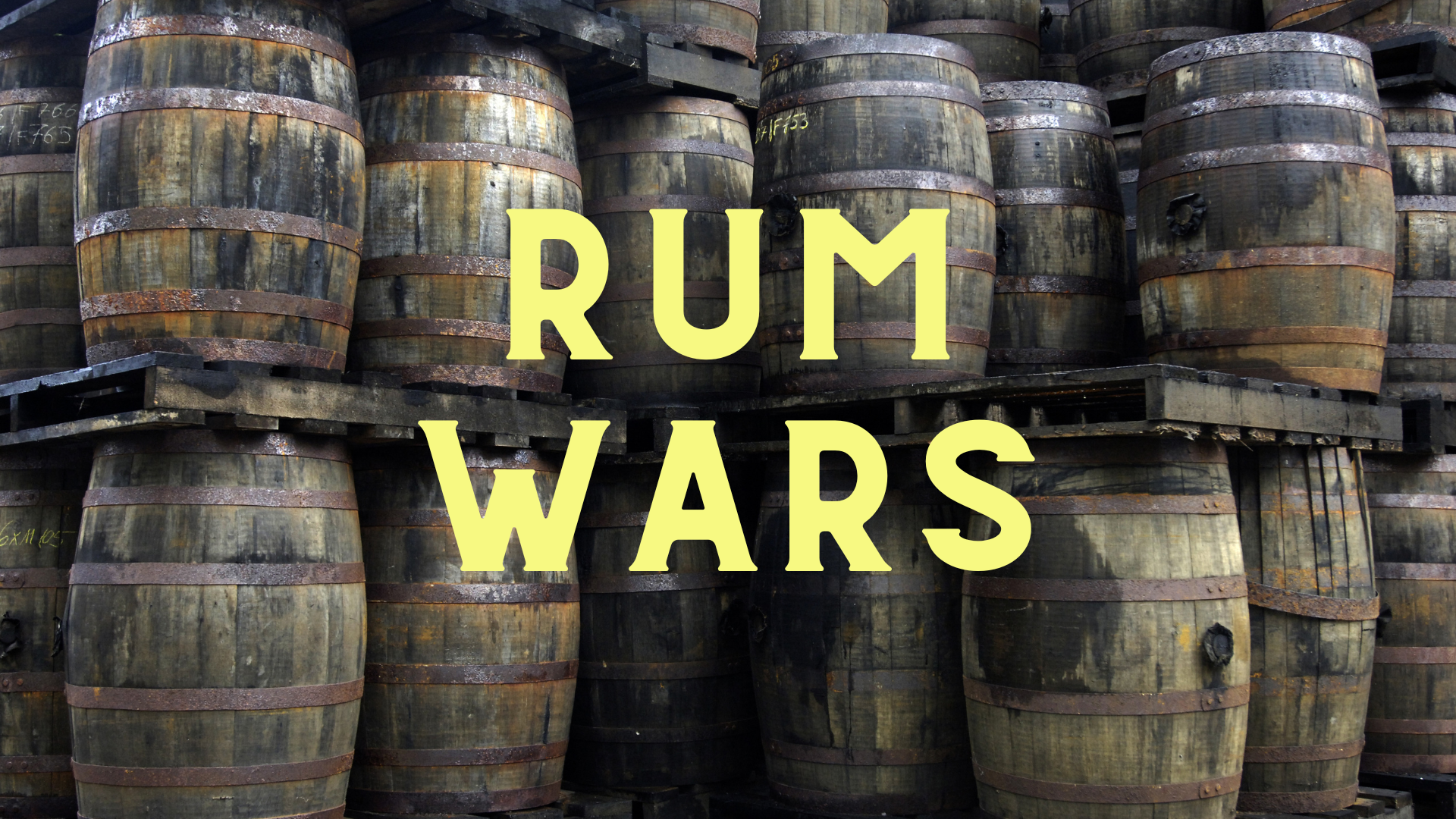 A background of old barrels stacked on top of one another with overlain text 'Rum Wars'
